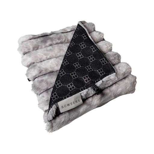 A folded gray faux fur blanket with a black triangular patterned panel and a visible BOWSERS brand tag, shown on a plain white background.