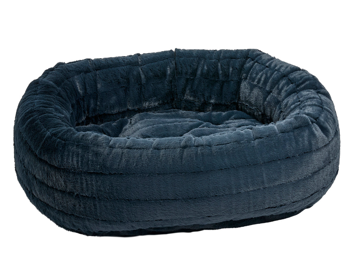 A plush, dark blue-gray circular pet bed with a ribbed, cushioned exterior and a matching soft interior, shown against a plain white background.