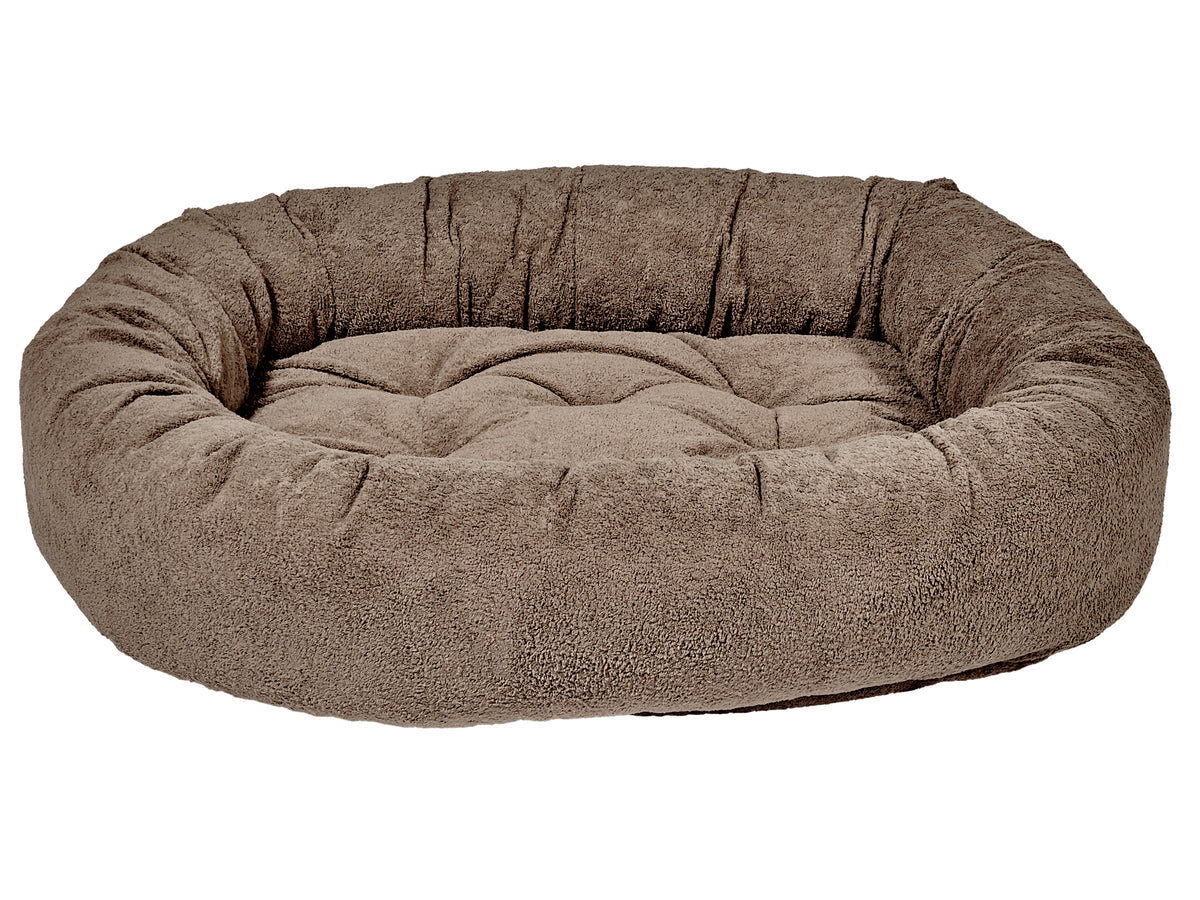 Brown donut-shaped pet bed on a white background