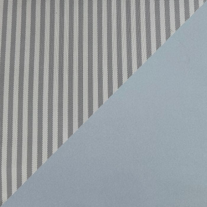 A close-up of a fabric or material sample with vertical gray and white stripes on the left and a smooth light blue-gray surface on the right, divided diagonally.