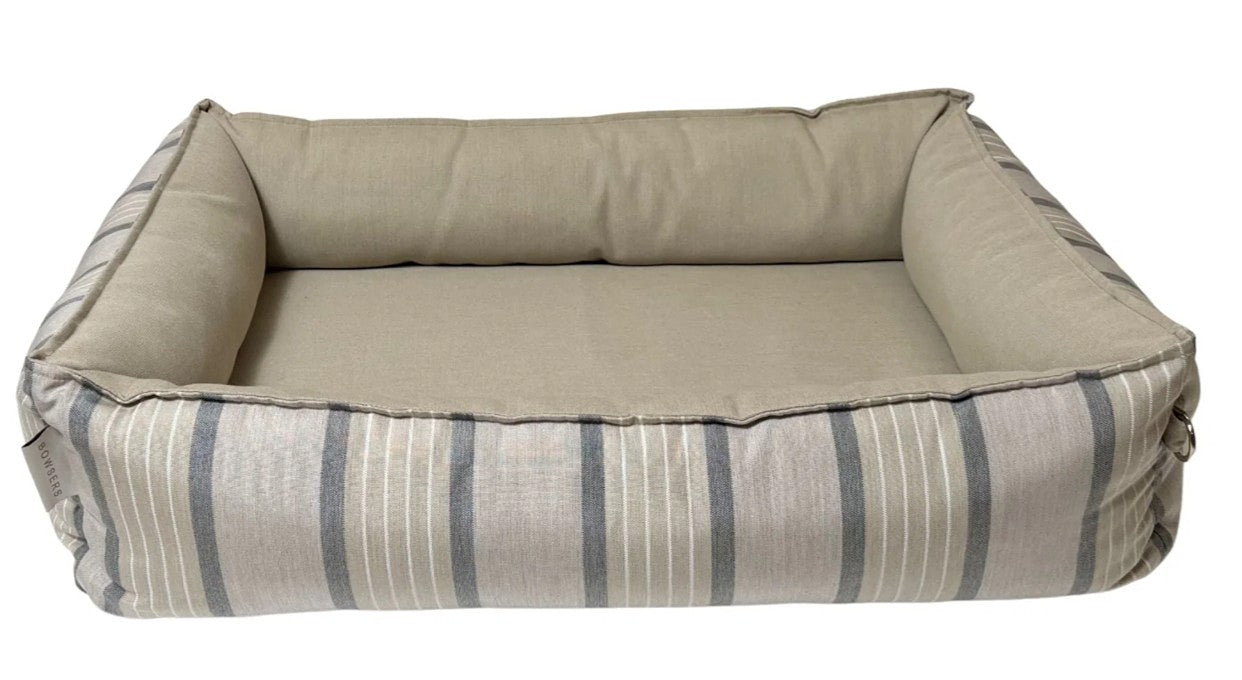 A rectangular outdoor pet bed with a beige cushioned interior and striped fabric sides in beige, gray, and white, shown against a plain white background.
